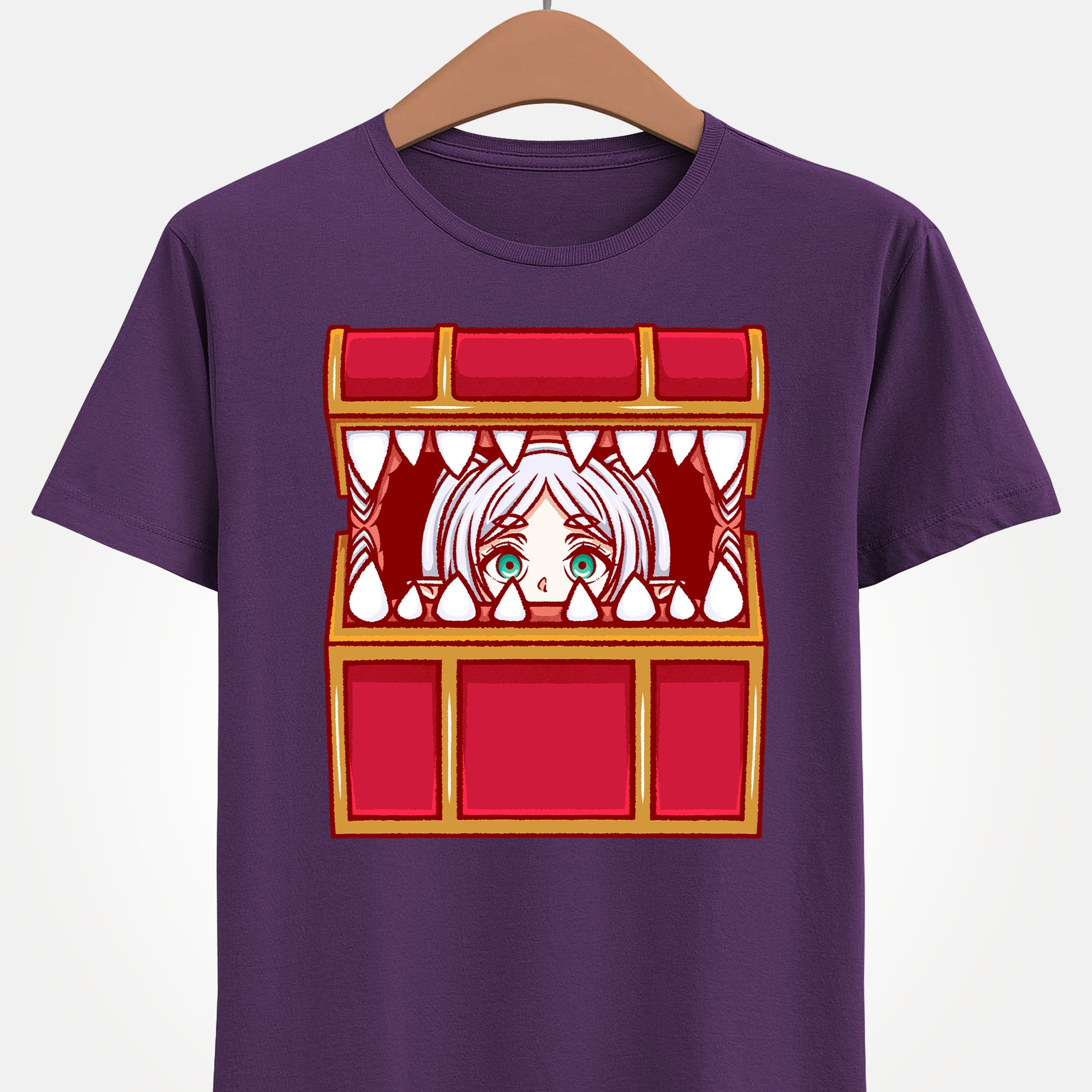 Frieren Mimic t-shirt inspired by Sōsō no Frieren: Beyond Journey’s End, featuring the elf mage protagonist being playfully eaten by a treasure chest mimic in a cute kawaii art style. This unisex anime shirt captures the viral meme loved by fans across the internet. Perfect fantasy anime merch for collectors, otaku enthusiasts, and fans of Frieren who enjoy funny dungeon moments and RPG-inspired designs.