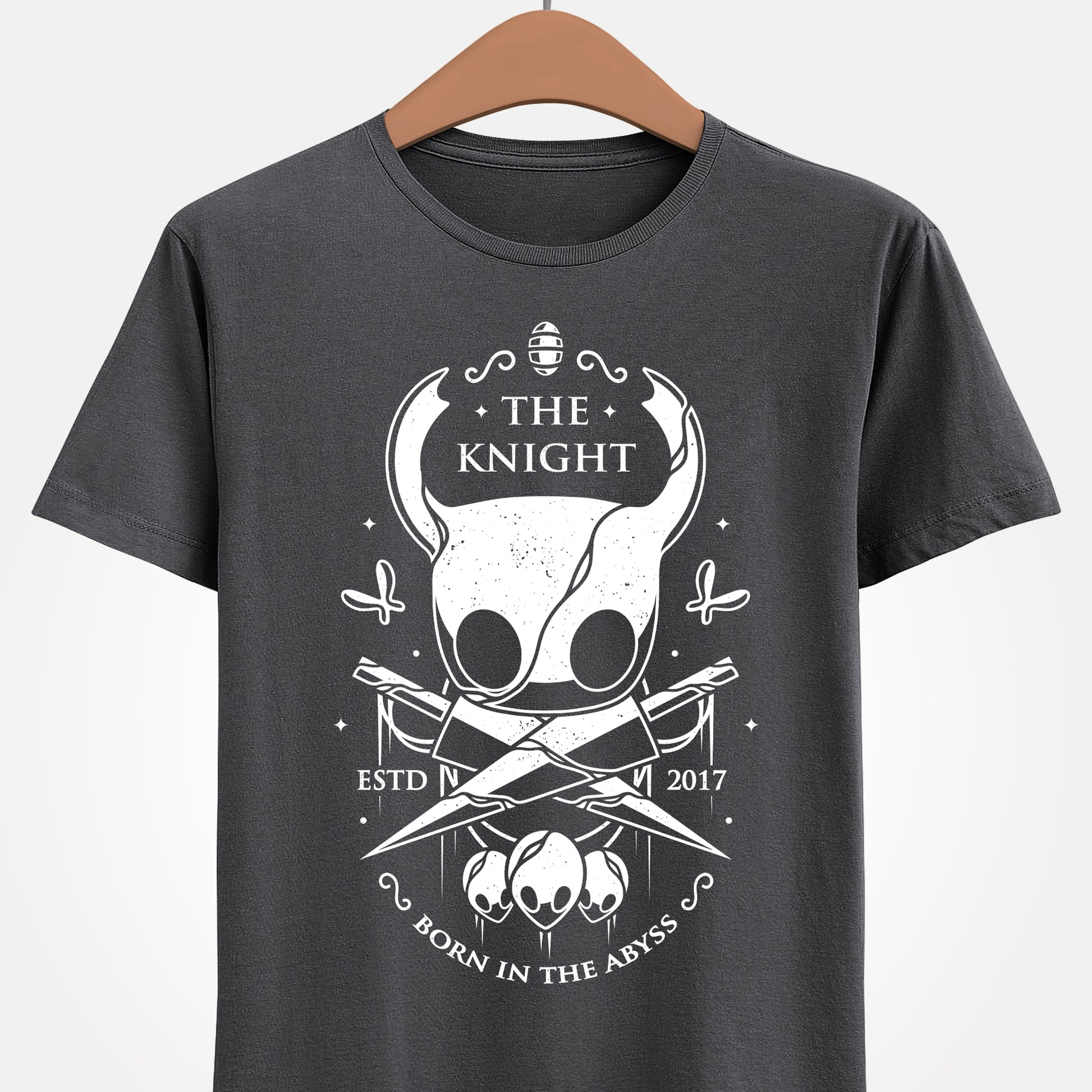 The Knight Hollow Knight t-shirt featuring the iconic Vessel from the indie metroidvania video game Hollow Knight. Atmospheric gamer apparel inspired by Hallownest, perfect for fans of The Knight, indie games, dark fantasy aesthetics, and Hollow Knight merch. Unisex video game shirt ideal as a gift for gamers and collectors. hollow knight merch, hollow knight the knight t-shirt, the knight hollow knight video game t-shirt, hollow knight exclusive merch, hollow knight silksong t-shirt