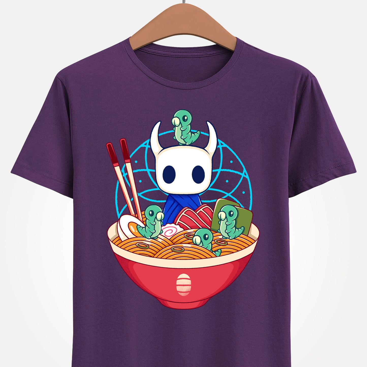 Cute Hollow Knight T-shirt featuring The Knight and adorable Grubs sitting inside a colorful ramen noodle bowl in a kawaii Japanese art style. The design blends food-themed illustration with indie game aesthetics, creating a fun and cozy look perfect for Hollow Knight fans, metroidvania lovers, ramen enthusiasts, and collectors. High-quality print ideal for gamers who enjoy cute cartoon art and unique fan-made apparel. hollow knight the knight ramen t-shirt, hollow knight ramen shirt, ramen tee