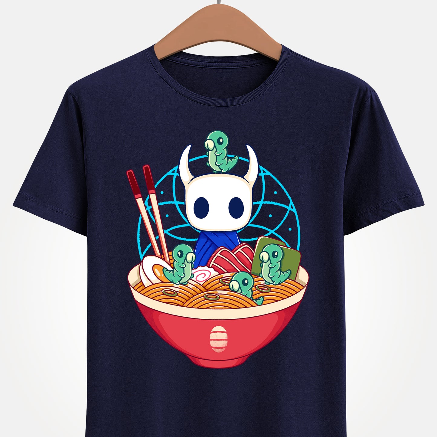 Cute Hollow Knight T-shirt featuring The Knight and adorable Grubs sitting inside a colorful ramen noodle bowl in a kawaii Japanese art style. The design blends food-themed illustration with indie game aesthetics, creating a fun and cozy look perfect for Hollow Knight fans, metroidvania lovers, ramen enthusiasts, and collectors. High-quality print ideal for gamers who enjoy cute cartoon art and unique fan-made apparel. hollow knight the knight ramen t-shirt, hollow knight ramen shirt, ramen tee