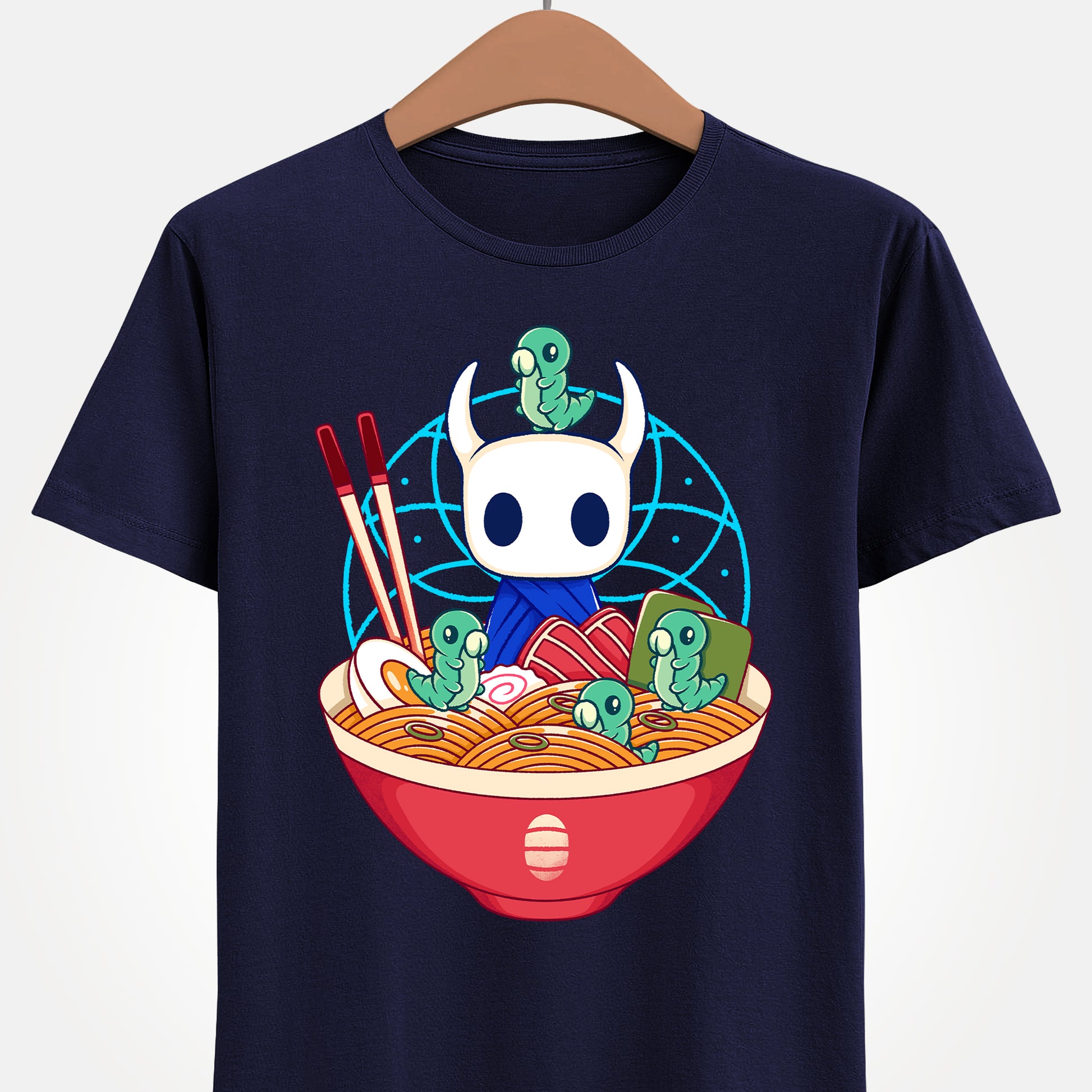 Cute Hollow Knight T-shirt featuring The Knight and adorable Grubs sitting inside a colorful ramen noodle bowl in a kawaii Japanese art style. The design blends food-themed illustration with indie game aesthetics, creating a fun and cozy look perfect for Hollow Knight fans, metroidvania lovers, ramen enthusiasts, and collectors. High-quality print ideal for gamers who enjoy cute cartoon art and unique fan-made apparel. hollow knight the knight ramen t-shirt, hollow knight ramen shirt, ramen tee