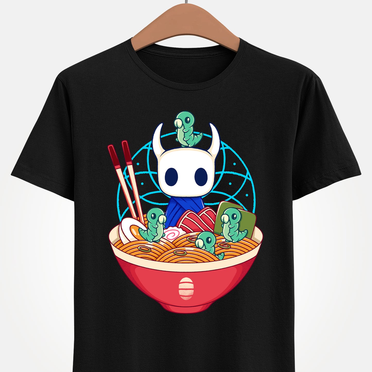 Cute Hollow Knight T-shirt featuring The Knight and adorable Grubs sitting inside a colorful ramen noodle bowl in a kawaii Japanese art style. The design blends food-themed illustration with indie game aesthetics, creating a fun and cozy look perfect for Hollow Knight fans, metroidvania lovers, ramen enthusiasts, and collectors. High-quality print ideal for gamers who enjoy cute cartoon art and unique fan-made apparel. hollow knight the knight ramen t-shirt, hollow knight ramen shirt, ramen tee