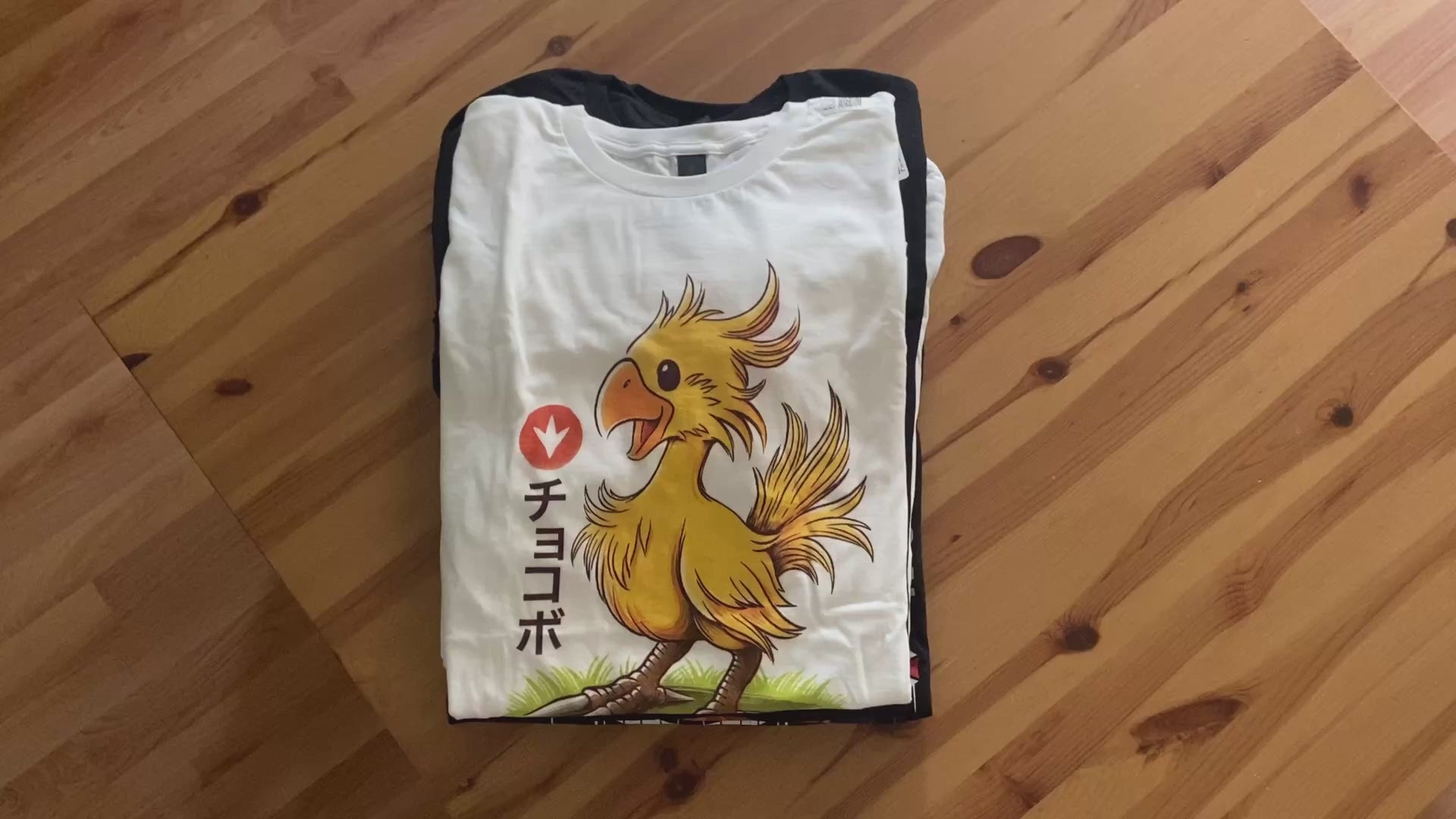 Load video: “High-resolution close-ups showing the Direct-to-Garment (DTG) printing process on premium heavy cotton Alundrart T-shirts. The video showcases vivid color accuracy, smooth ink gradients, and precise line detail in video game-inspired designs such as Hollow Knight, Final Fantasy, Resident Evil 3, and Studio Ghibli movies. Printed on Gildan 5000 blanks with durable, soft-touch finish for gamers who value quality and authentic artwork.”
